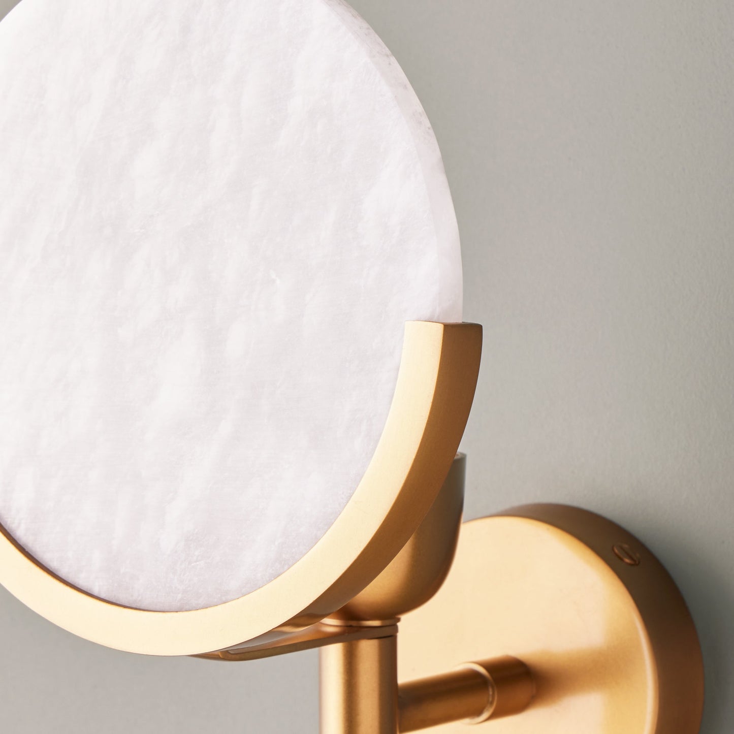 Firefly wall light in antique brass with an alabaster globe