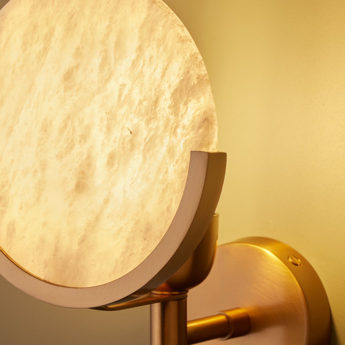 Firefly wall light in antique brass with an alabaster globe