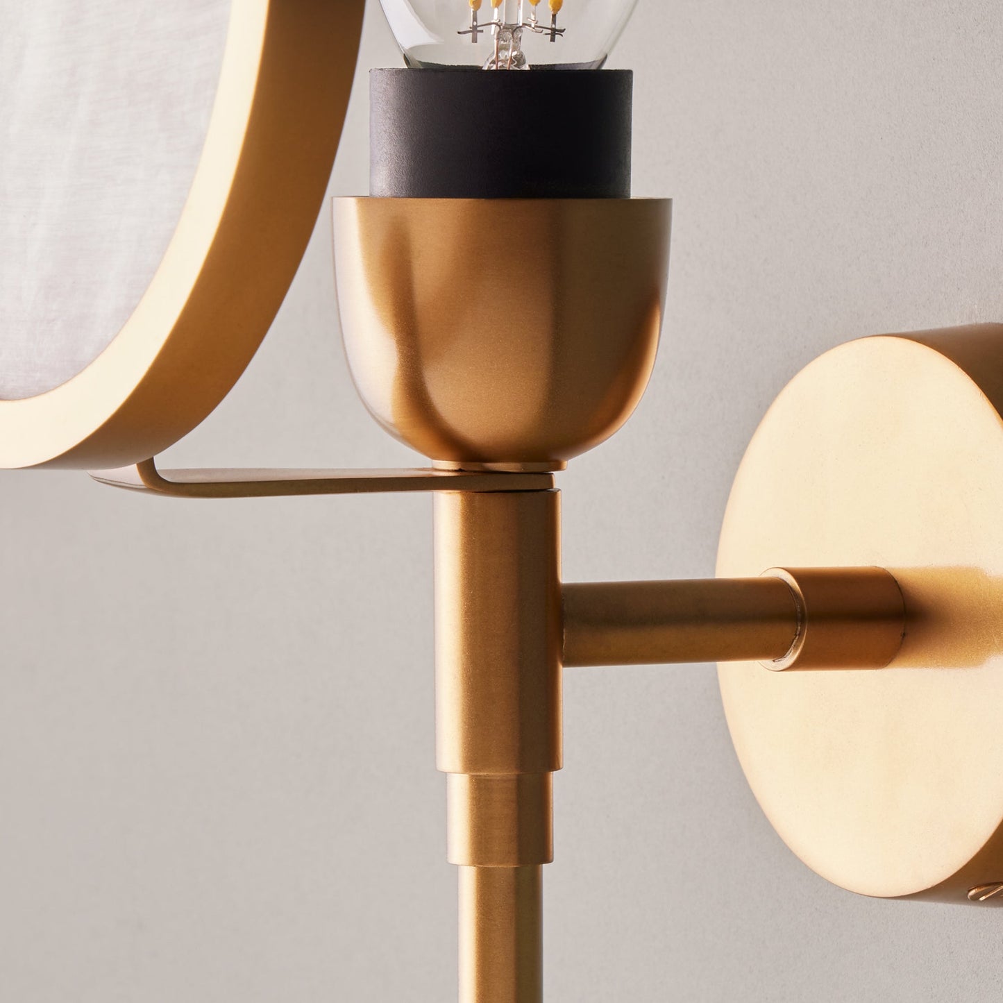 Firefly wall light in antique brass with an alabaster globe