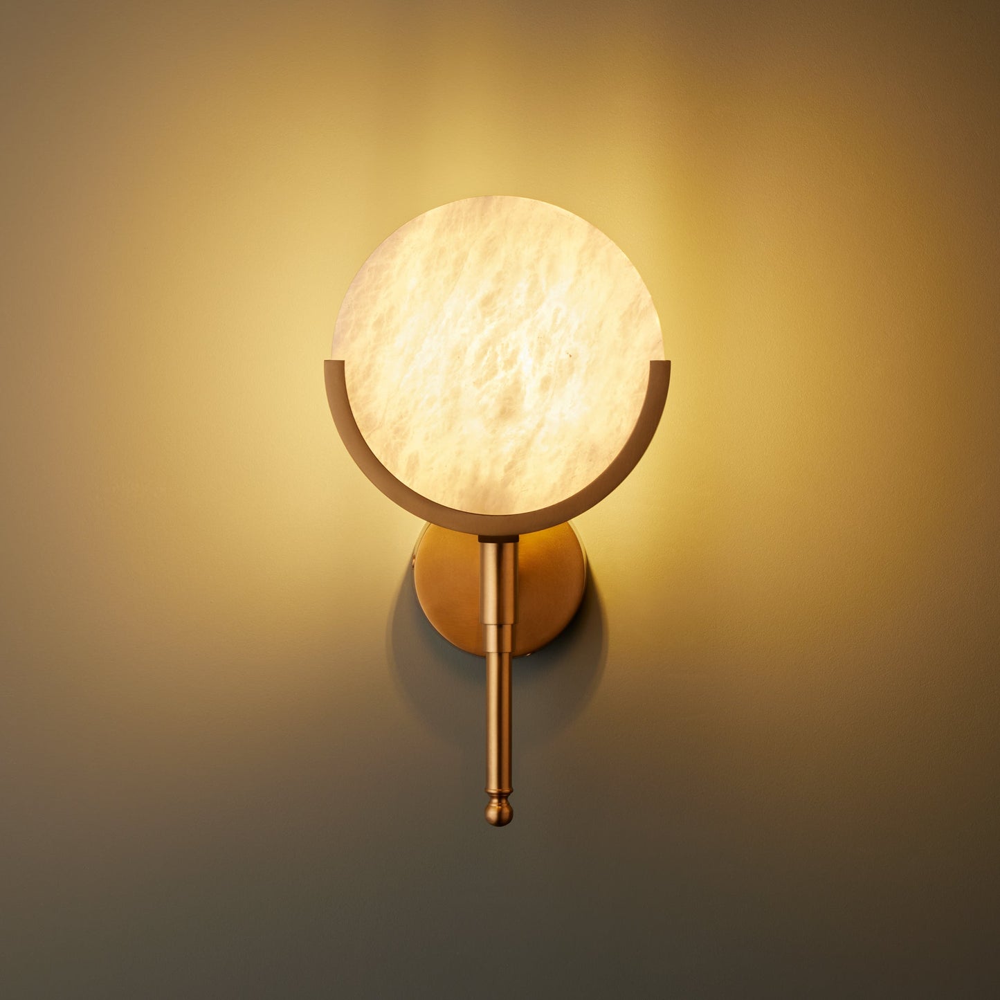 Firefly wall light in antique brass with an alabaster globe