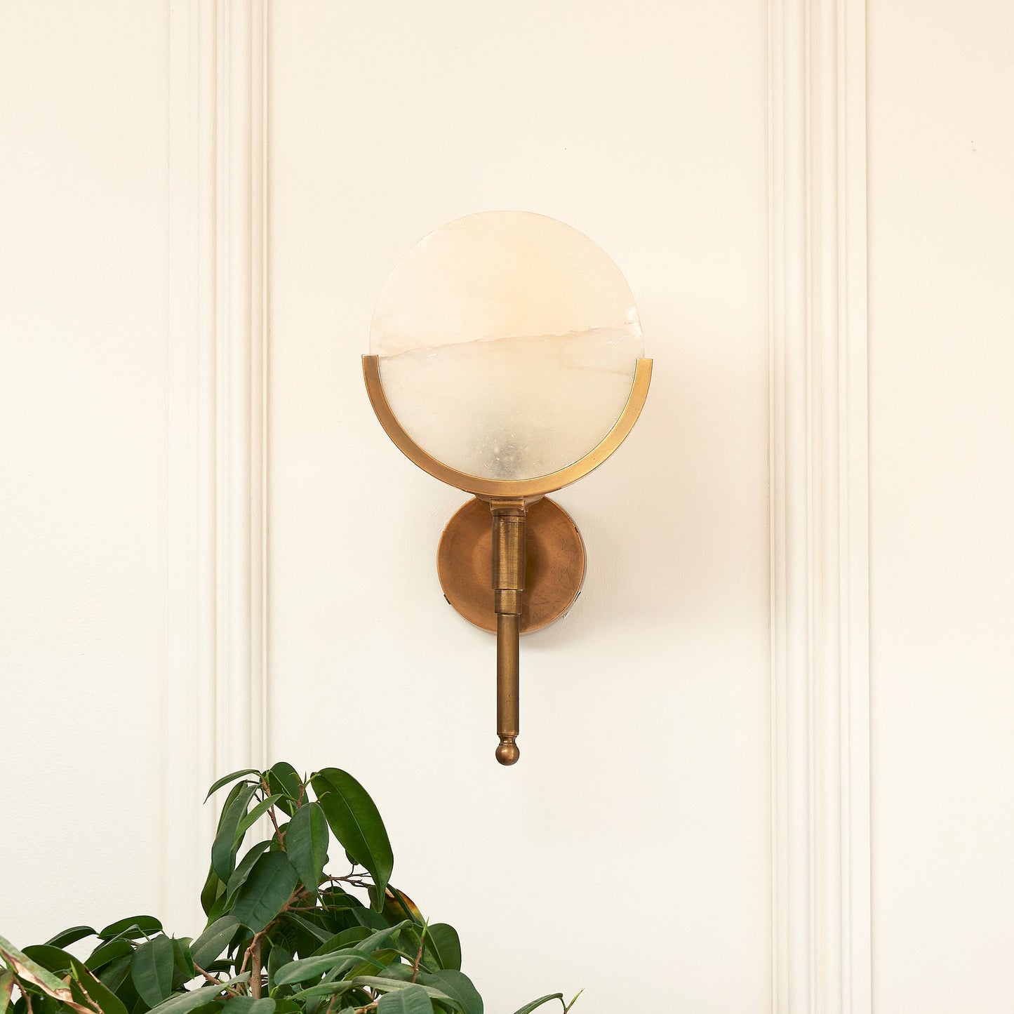Firefly wall light in antique brass with an alabaster globe