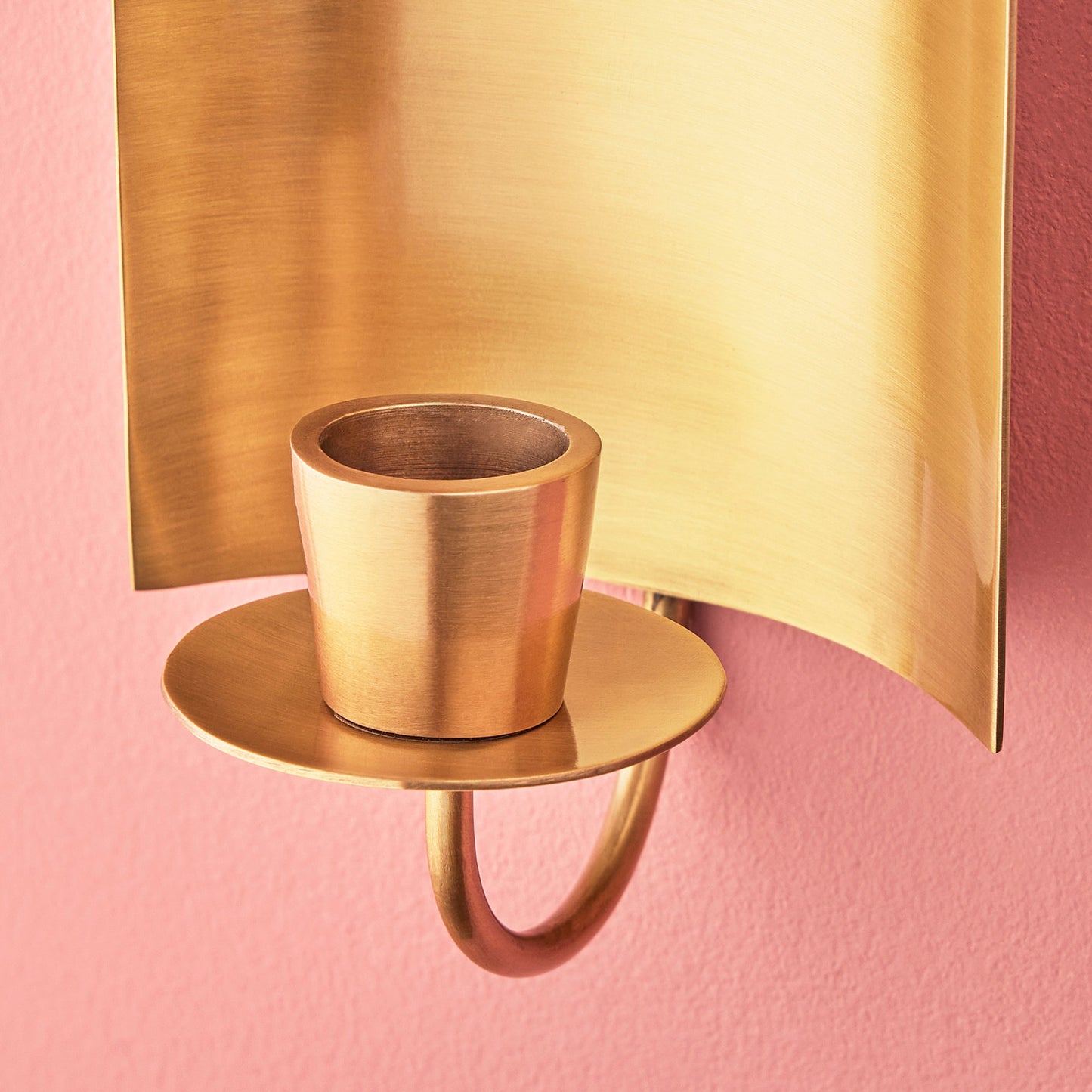 Pitti wall mounted candle holder in antiqued brass