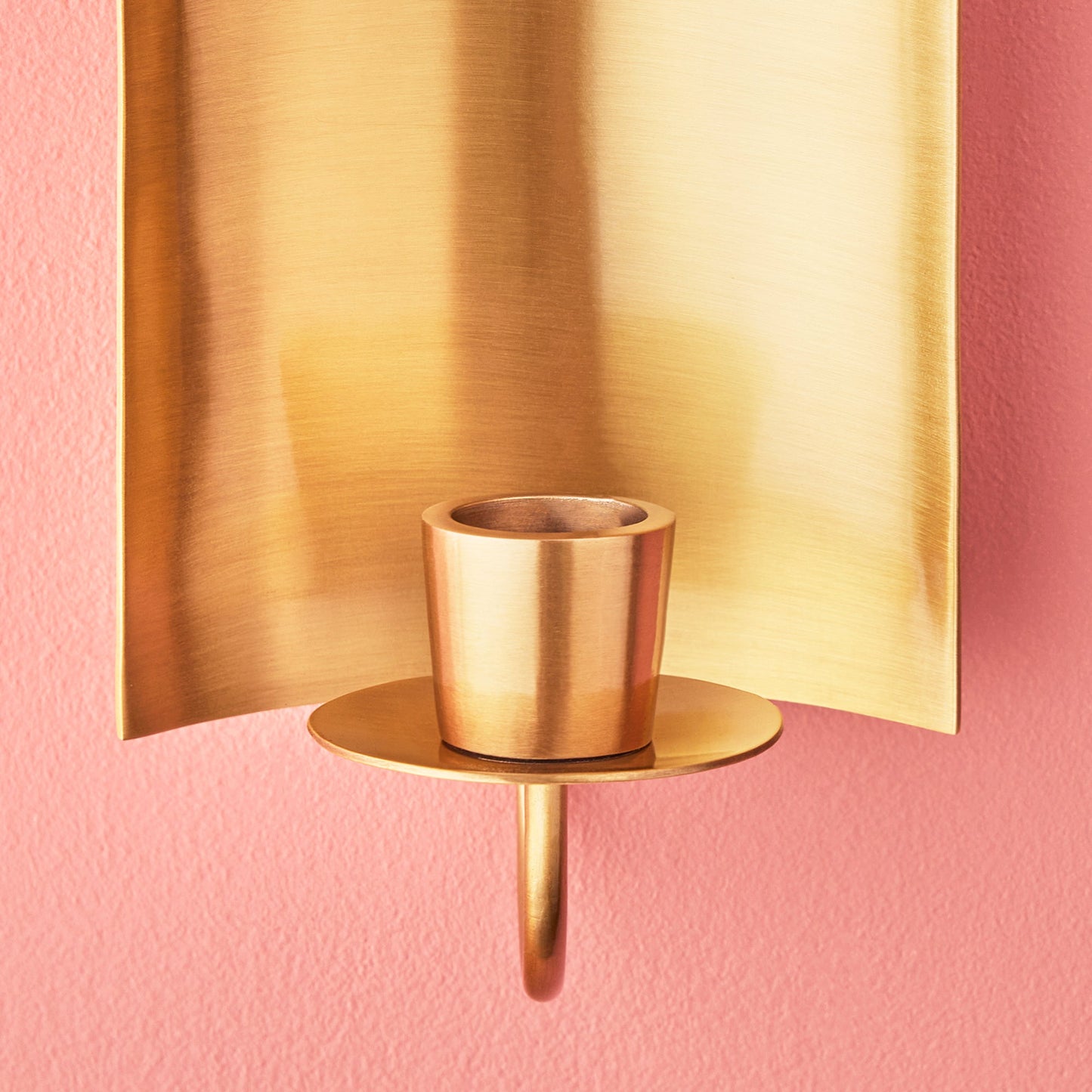 Pitti wall mounted candle holder in antiqued brass