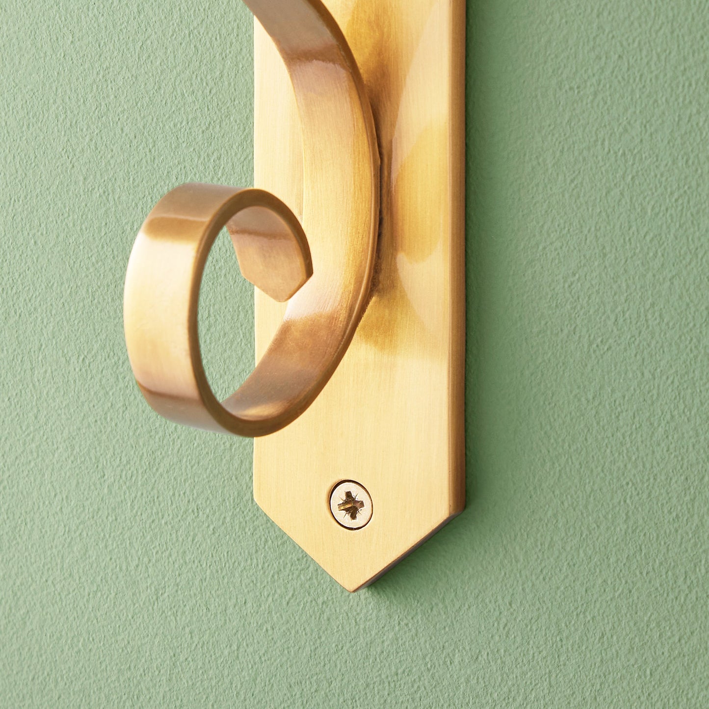 Tivoli wall mounted candle holder in antiqued brass