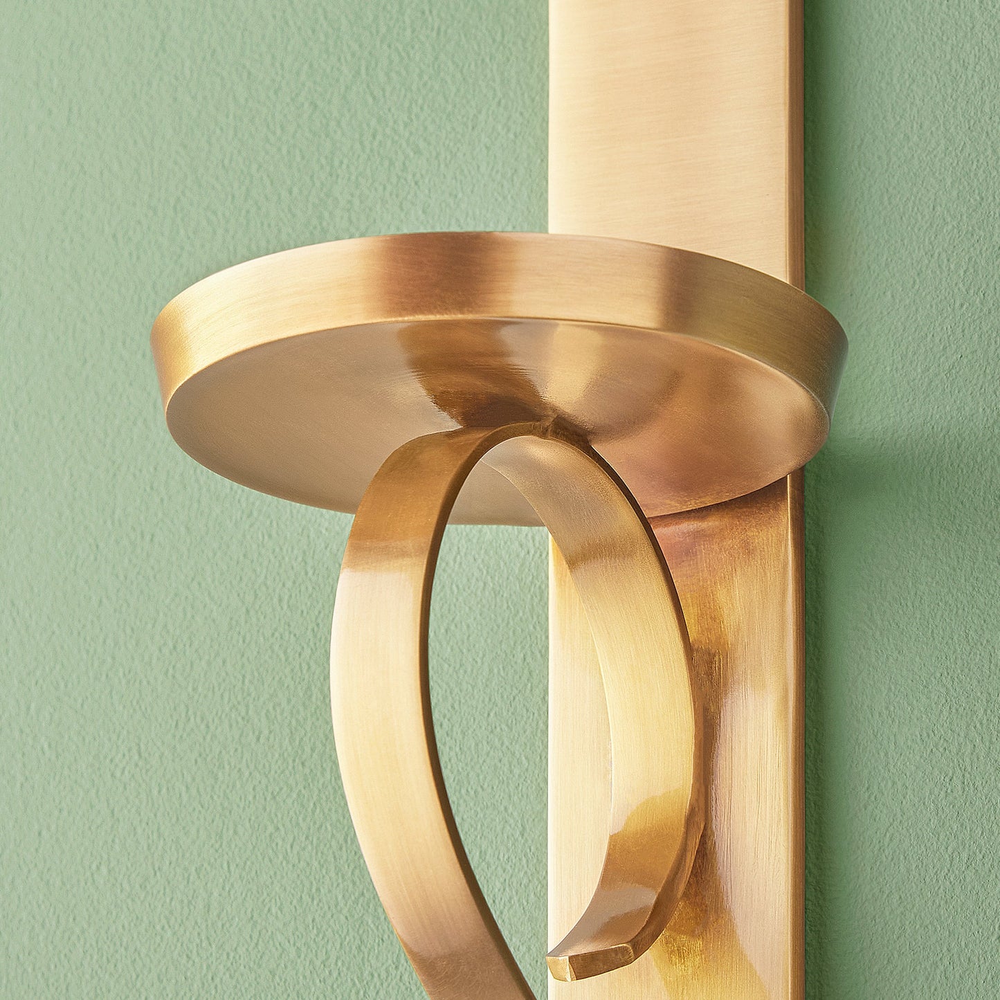 Tivoli wall mounted candle holder in antiqued brass