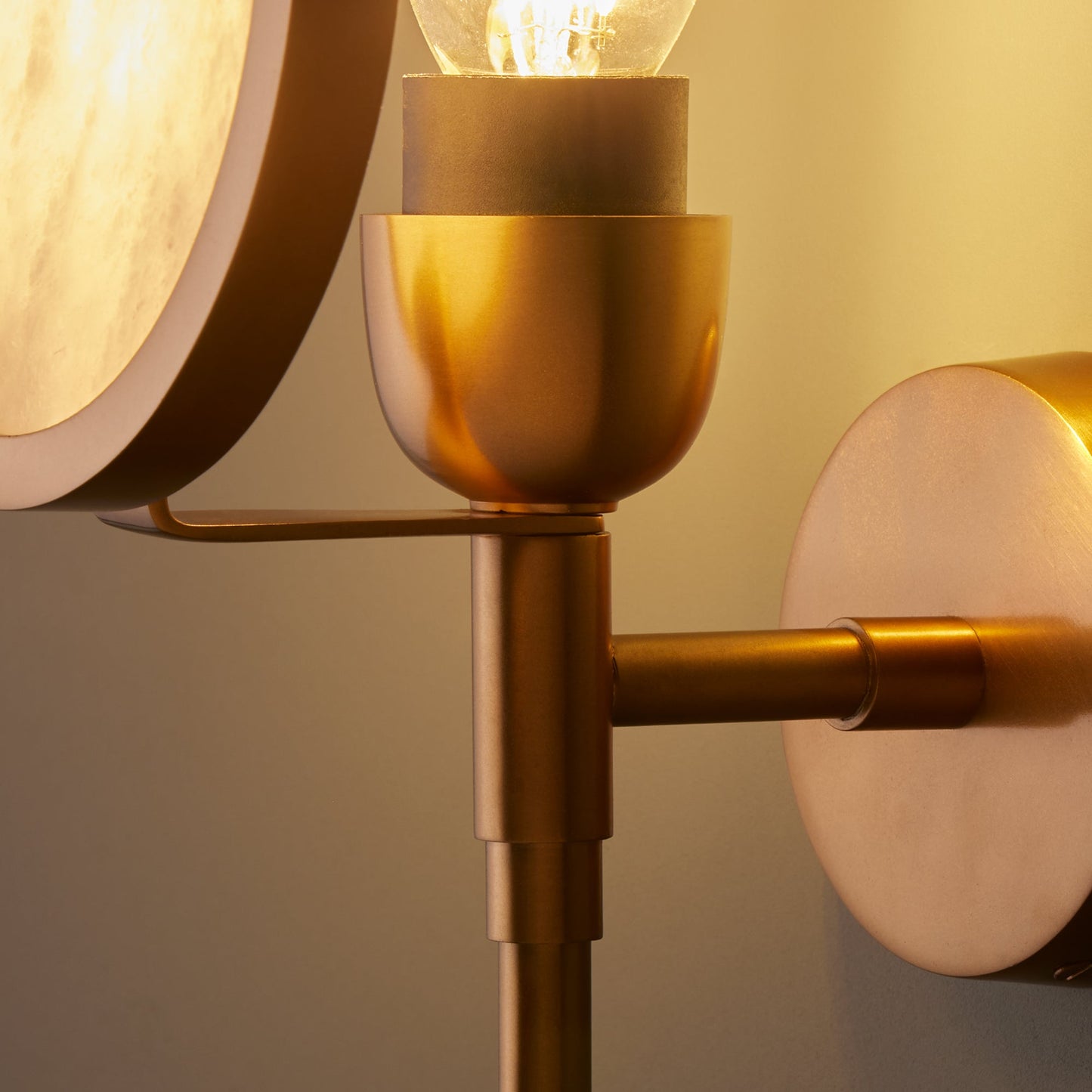 Firefly wall light in antique brass with an alabaster globe