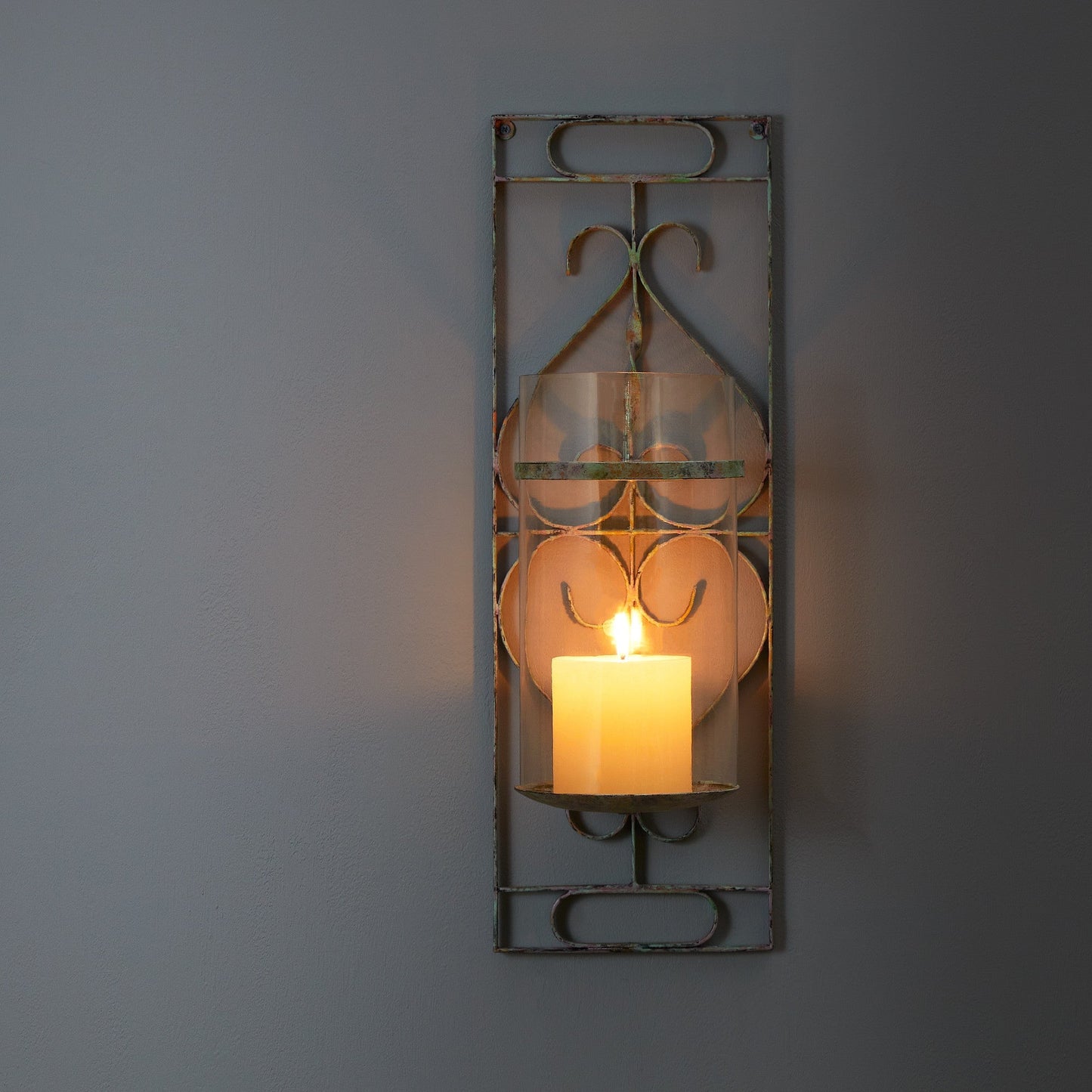 Tor wall mounted candle sconce in verdigris
