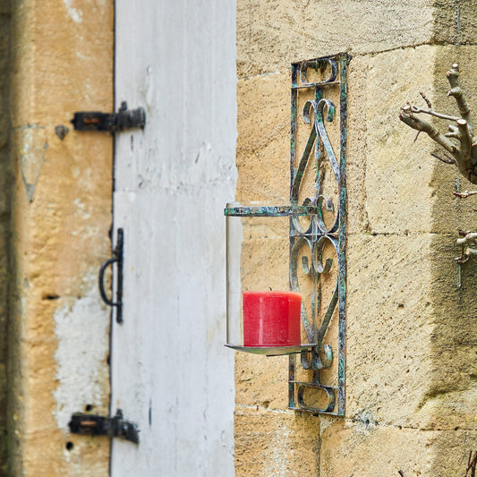Tor wall mounted candle sconce in verdigris