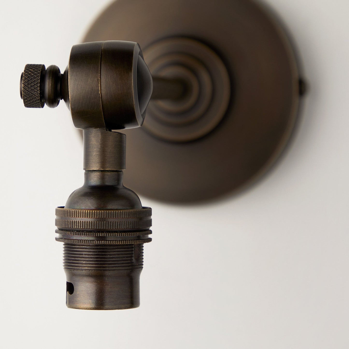 Elbow wall fitting in antiqued bronze