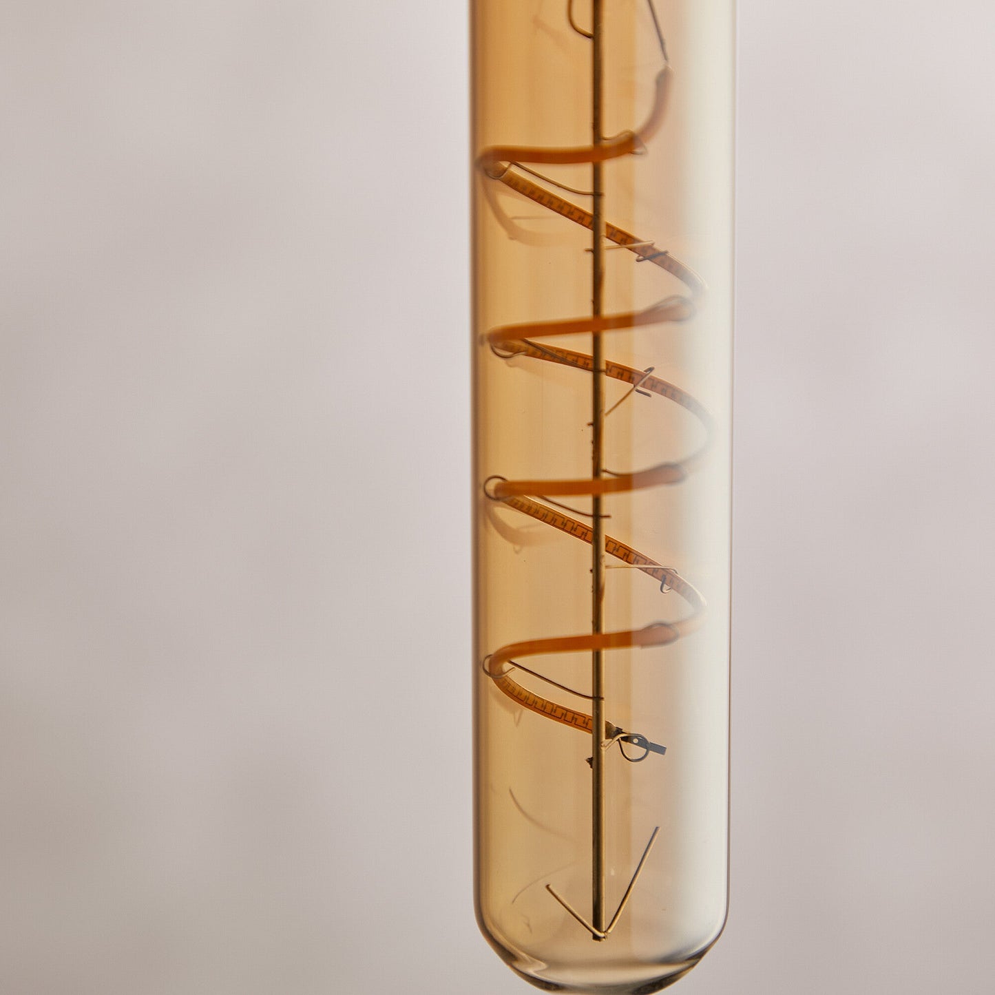 Long thin 4 watt LED curled filament bulb with amber coating and B22 fitting