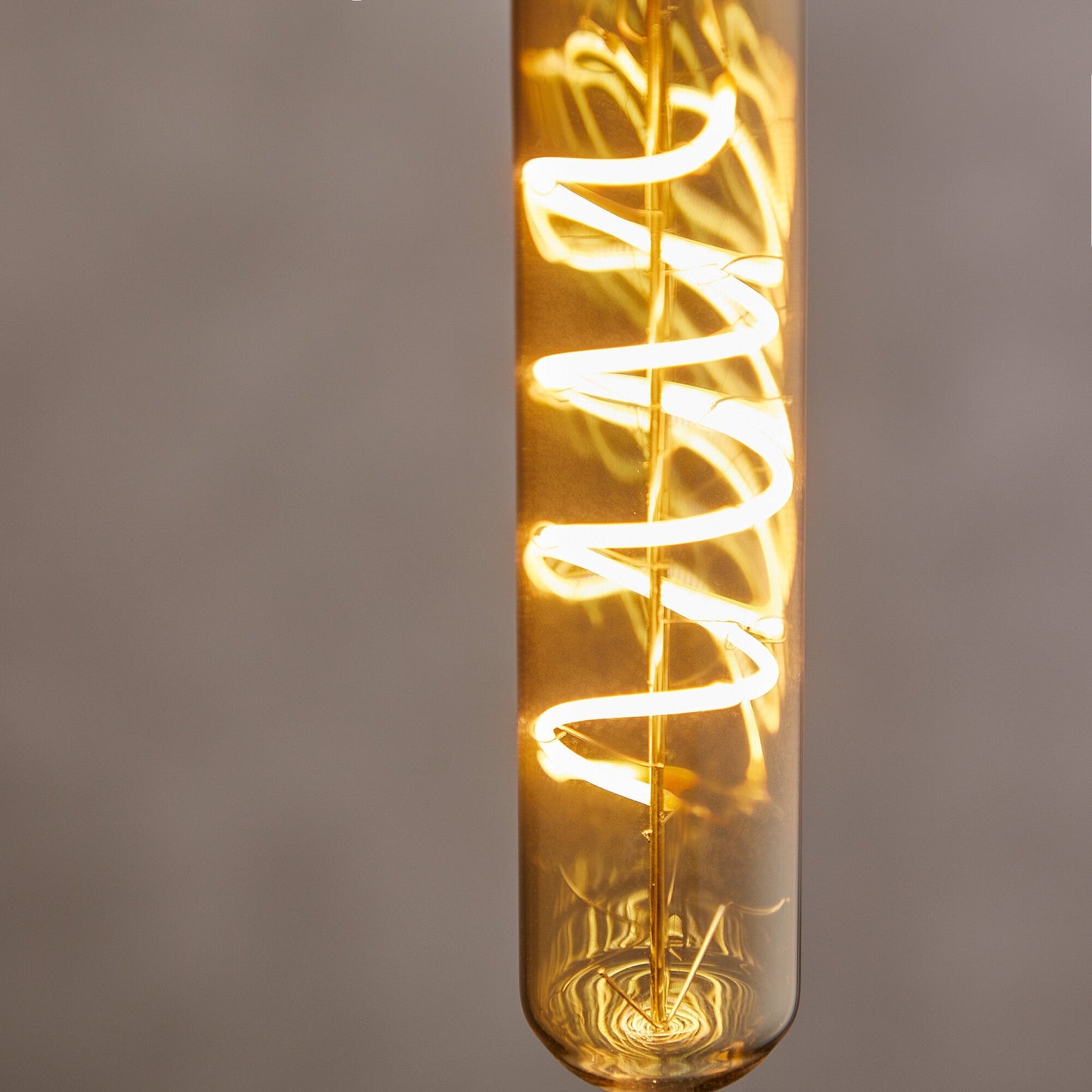 Long thin 4 watt LED curled filament bulb with amber coating and B22 fitting