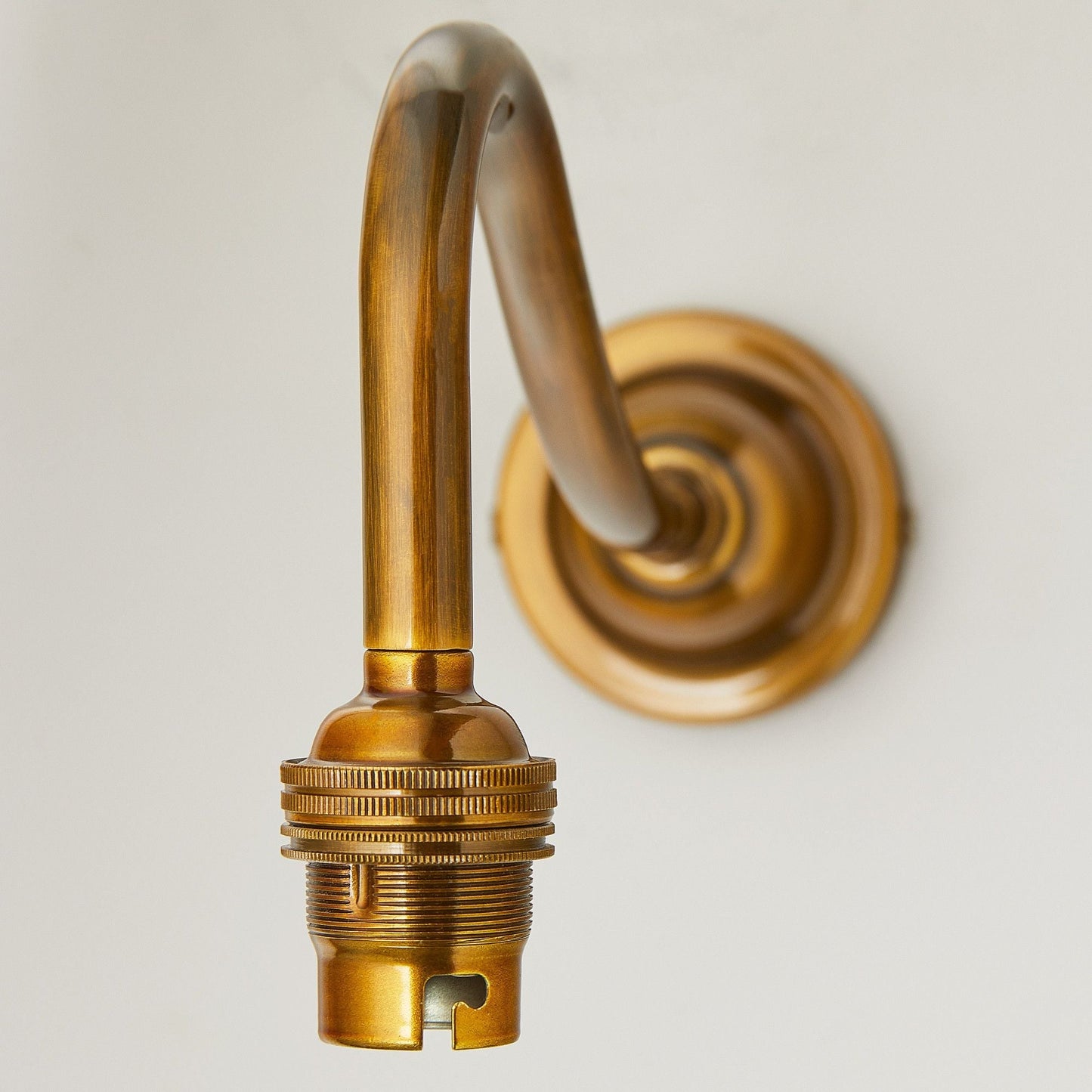 Swan neck wall fitting in antiqued brass
