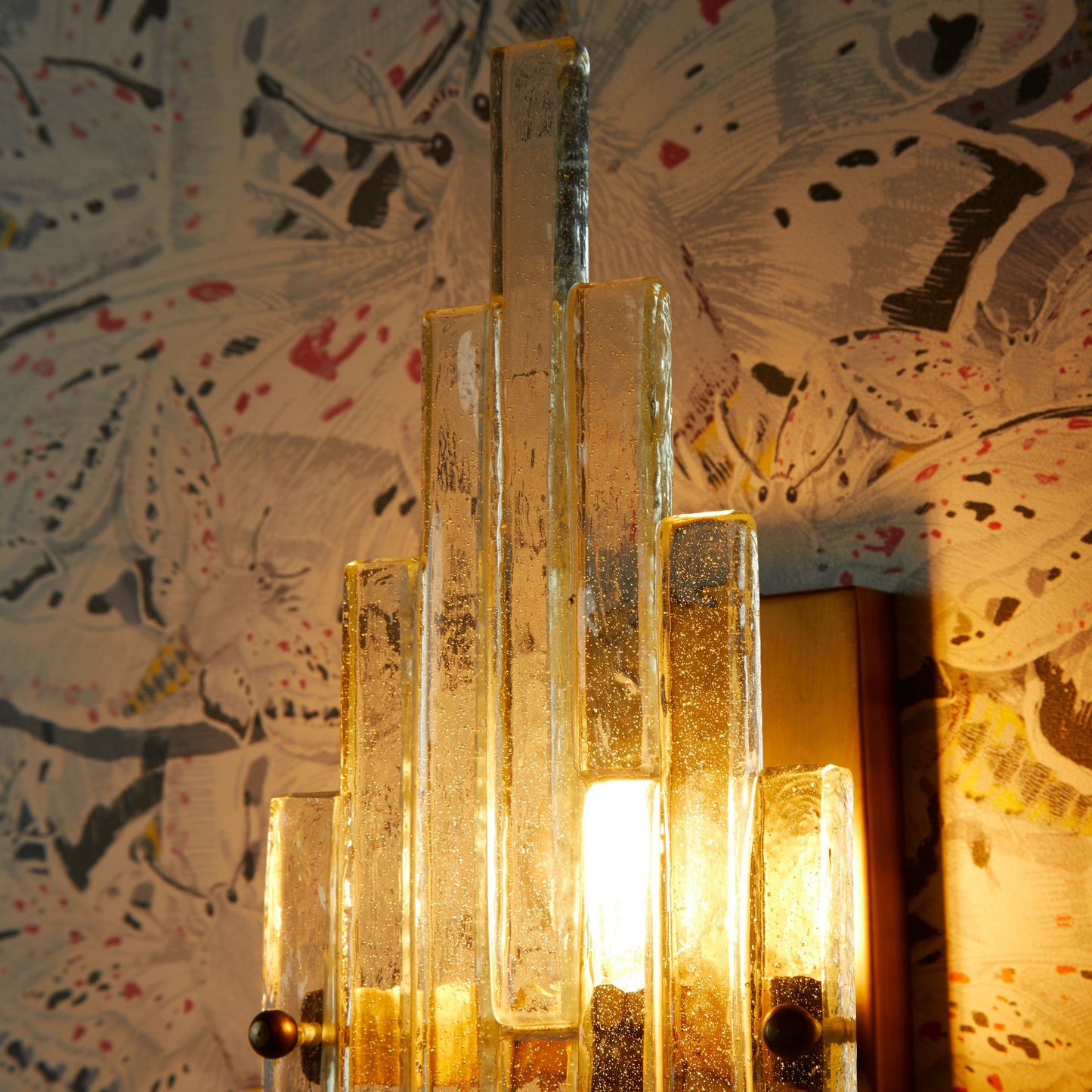 Skystar wall sconce with stepped clear recycled glass strips